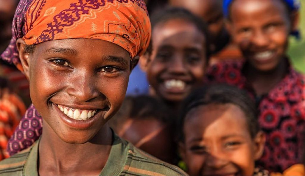 Happy sudanese lady with children in the background Happy sudanese lady with children in the background