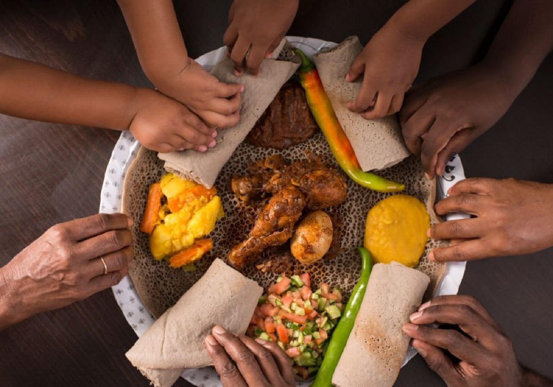 Hands taking wrap from plate